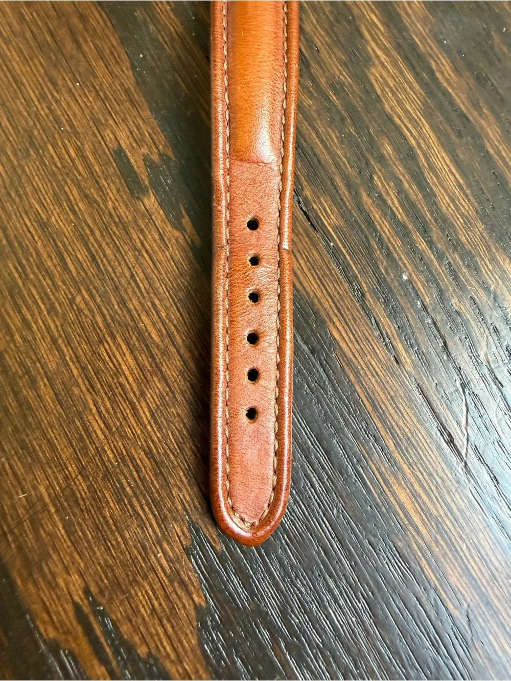 Vintage Levi’s quartz watch with a dark blue dial and a brown leather strap.